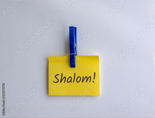 Shalom written on clipped yellow note