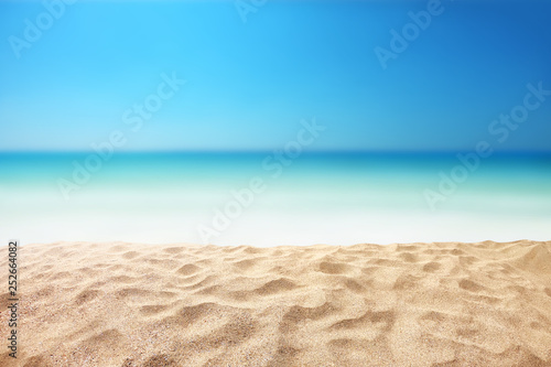 beautiful sandy beach with blur ocean background summer concept