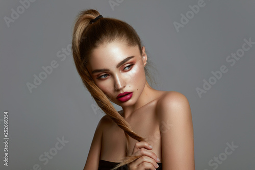 Glamour portrait of young pretty girl with long twisted hair