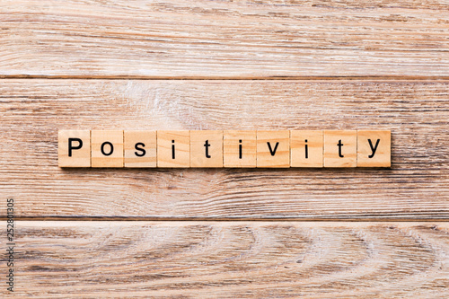 positivity word written on wood block. positivity text on wooden table for your desing, concept