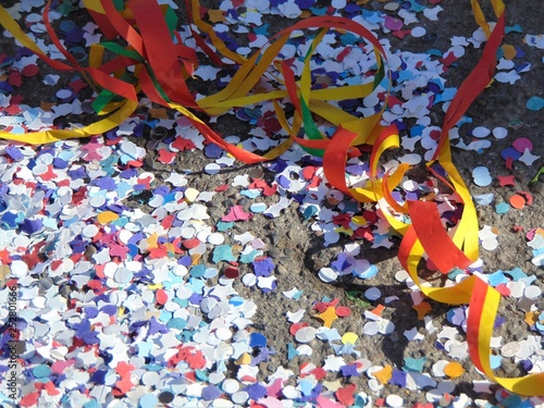 Colorful carnivalbackground with garlands, streamer, confetti on asphalt