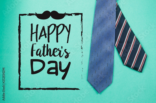 Happy Father's Day text with ties on green paper background