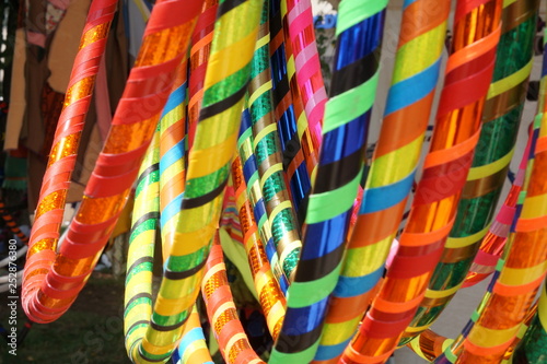 A rack full of multi-colored hula hoops