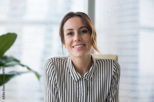 Smiling businesswoman looking at camera webcam make conference business call