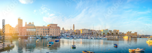 Bari, Puglia, Italy - Panoramic view of waterfront and harbor with boats - Margherita theater, cathedral and fort of Sant'Antonio. Panorama at sunset