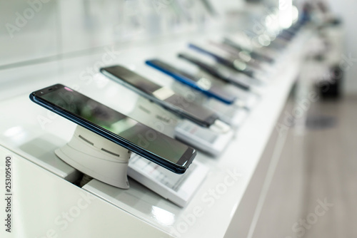 Smartphones on shelf in the store. Concept for communications and technology.