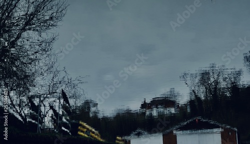 Tranquil River with Tree Reflections and Boat Club – Scenic Waterside View