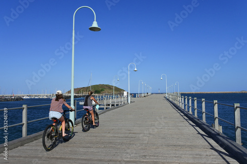 Two women cyling on Coffs Harbour Jetty New South Walse Australia