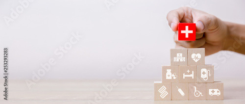 Health Insurance Concept,hand arranging wood block stacking with icon healthcare medical,for health.