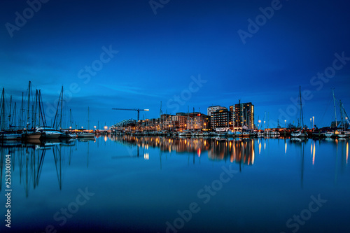 Aarhus Ø seen at night time with water reflections and Aarhus Marina in the foreground
