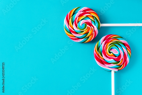 Colorful lollipops on blue background. Copyspace