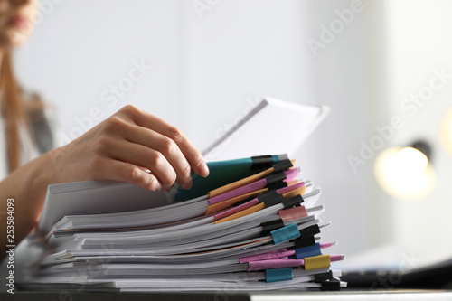 Office employee working with documents at table, closeup