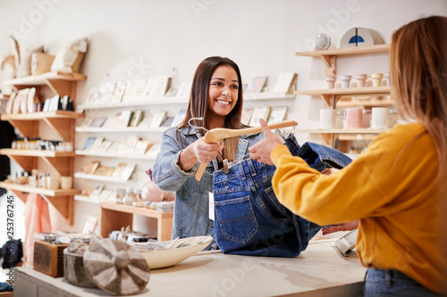 Female Sales Assistant In Independent Clothing And Gift Store Serving Female Customer