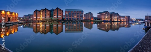 Gloucester docks warehouses reflected in quay on Sharpness Cana