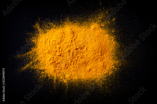 Curcuma turmeric spice powder on black background