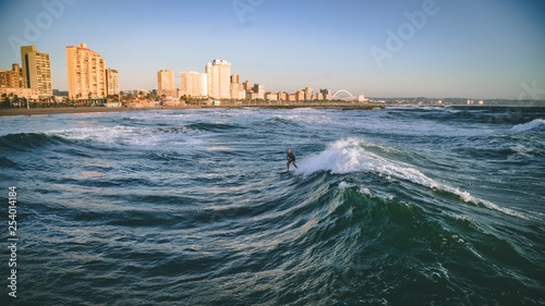 Surfer with city in background 