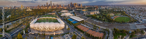 Aerial panoramic dawn view of the MCG Punt Road Oval, home of the Richmond Tigers AFL club and AAMI stadium, with the CBD in the background