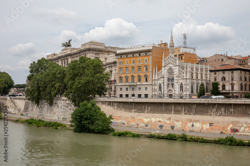 Panoramic view of city Rome with river Tiber and old church on other coast