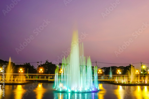 The colorful of fountain on the lake at night.