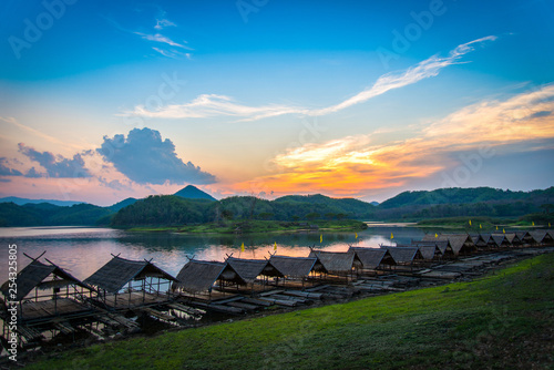 Landscape of river sky sunset mountain and bamboo houseboat raft floating on riverside for relax in holiday