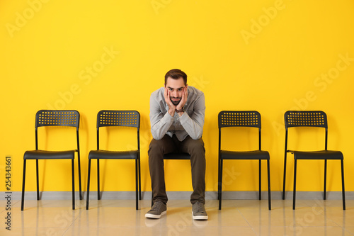 Young man waiting for job interview indoors