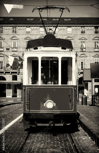 Vintage looking photo of the historical tramway line stops in Piazza Castello, main square of Turin (Italy)