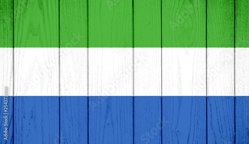 Flag of Sierra Leone on wooden background