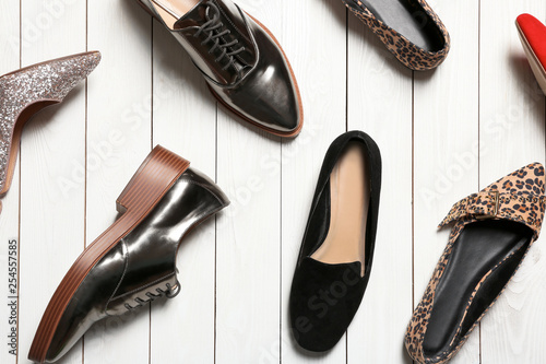 Flat lay composition with stylish shoes on wooden background