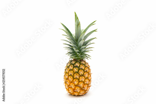 Pineapple with green leaves isolated on white background.