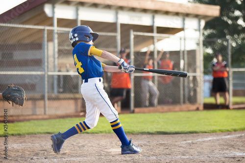 Youth baseball batter swinging