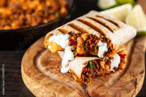 Mexican burrito with beef, beans and sour cream