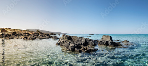 panoramic sunny landscape with turquoise sea and rocks