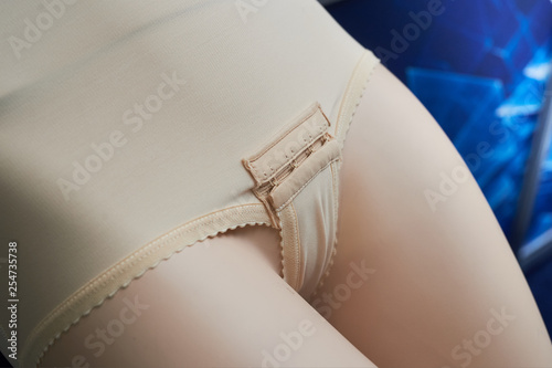 A sample of female bandage on a mannequin for the abdomen and buttocks, designed to be worn after surgical removal of fat and giving the necessary shape and plastic.