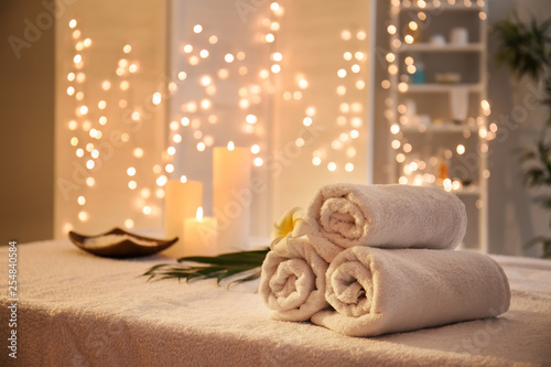 Rolled towels on table in spa salon