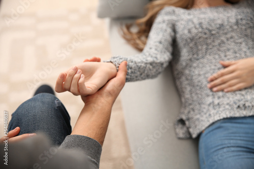 Male psychologist working with patient lying on sofa in his office