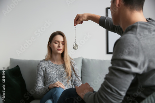 Young woman during hypnosis session in psychologist's office