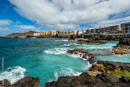 Tourism and travel. Windy day on the ocean. Rocky coast. Canary Islands, Gran Canaria, Atlantic Ocean. Tropics. City of Las Palmas