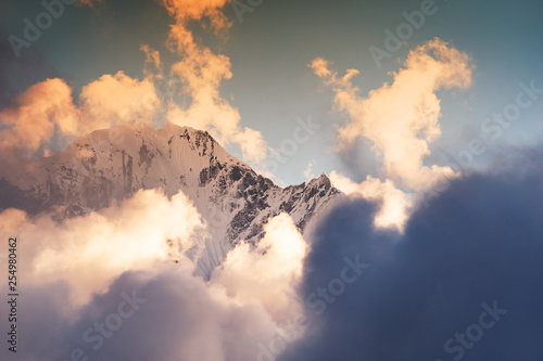 Himalaya mountain peaks with clouds at sunset. Nepal