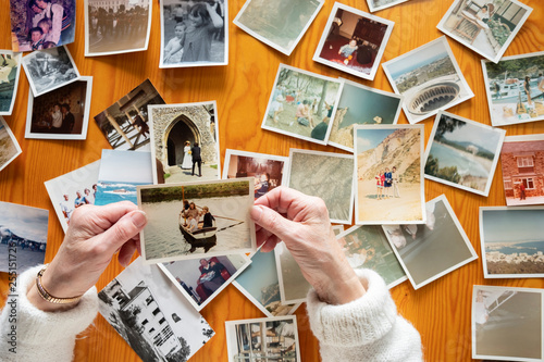 Top view of a senior caucasian woman looking at an old photos themes of memories nostalgia photos retired