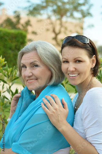 Portrait of cute senior woman with daughter at park