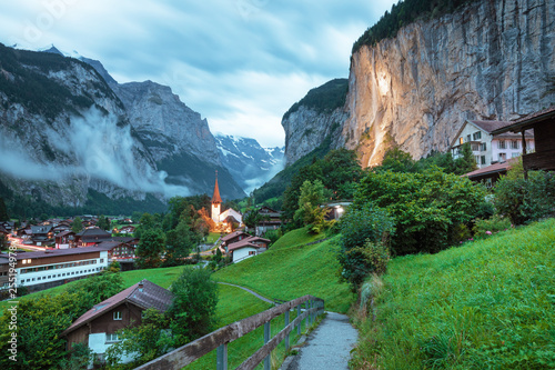 Amazing touristic alpine village with famous church and Staubbach waterfall, Lauterbrunnen, Switzerland, Europe