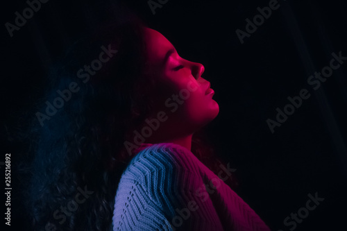 Gelled Red and Blue Light. Beautiful, Biracial High School Senior with Curly Hair