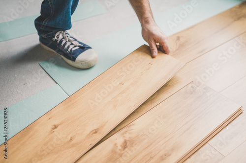 A man worker lays laminate - professional construction and finishing services