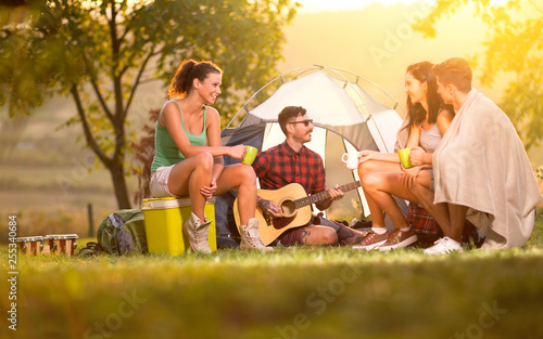 Young people on camping trip spending time together