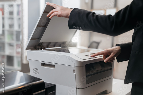 Business woman is using the printer to scanning and printing document