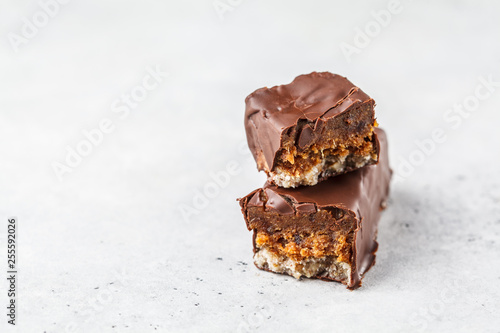 Vegan cocoa dates chocolate raw bars on white background.