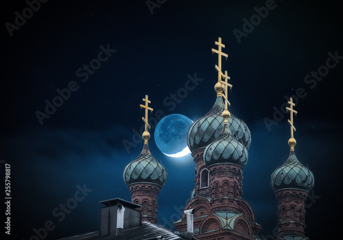 The golden domes of the orthodox church in night and moon