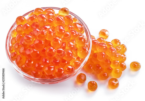 Red caviar in the bowl on white background.