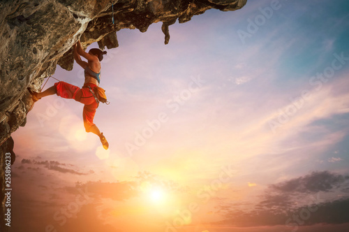 Woman climbing on rock