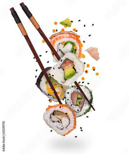 Pieces of delicious japanese sushi frozen in the air. Isolated on white background